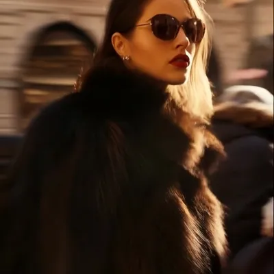 model moving slowly in a photoshoot, looking at the camera